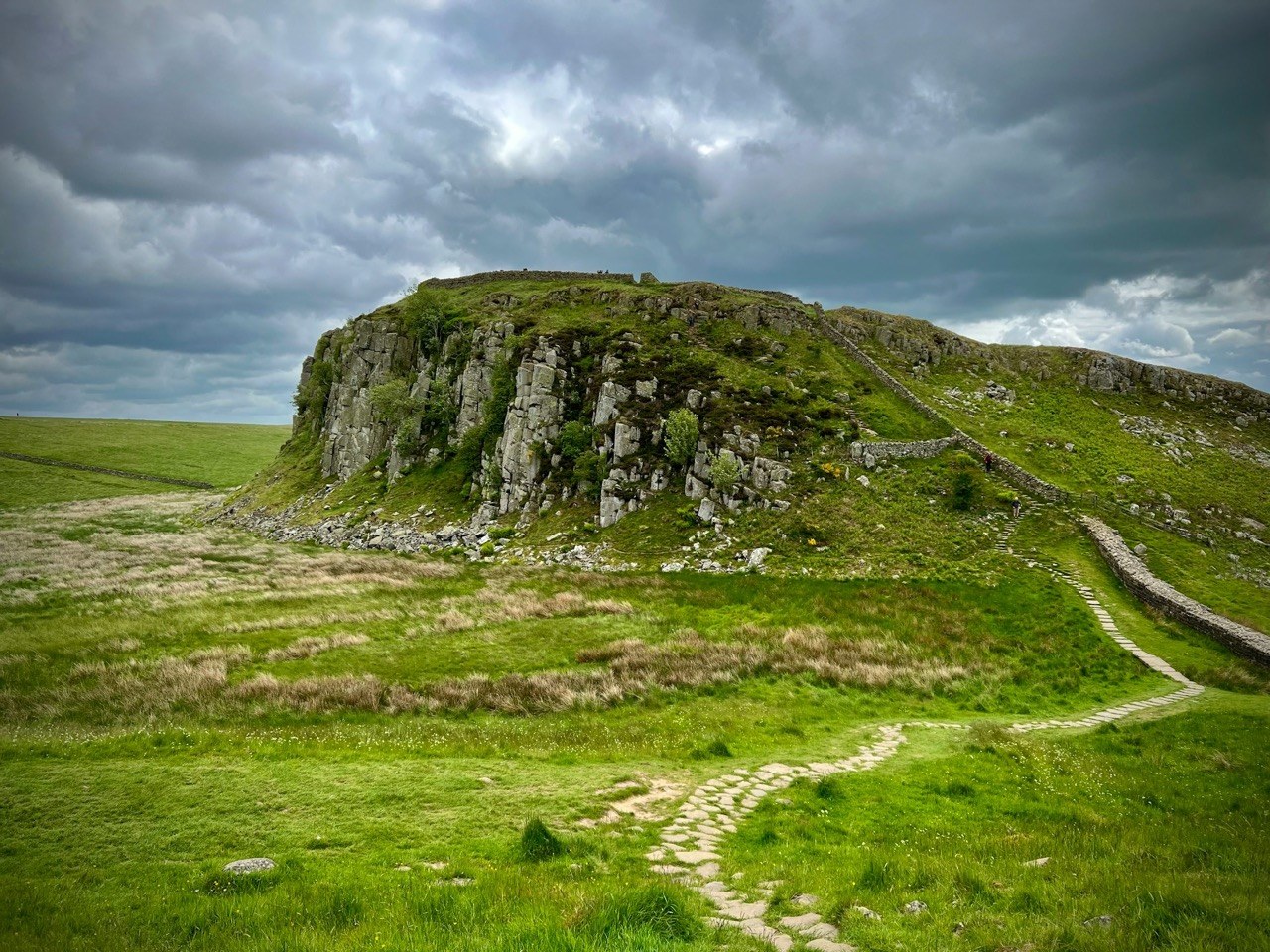 Hikers walking along Hadrian’s Wall near Sycamore Gap