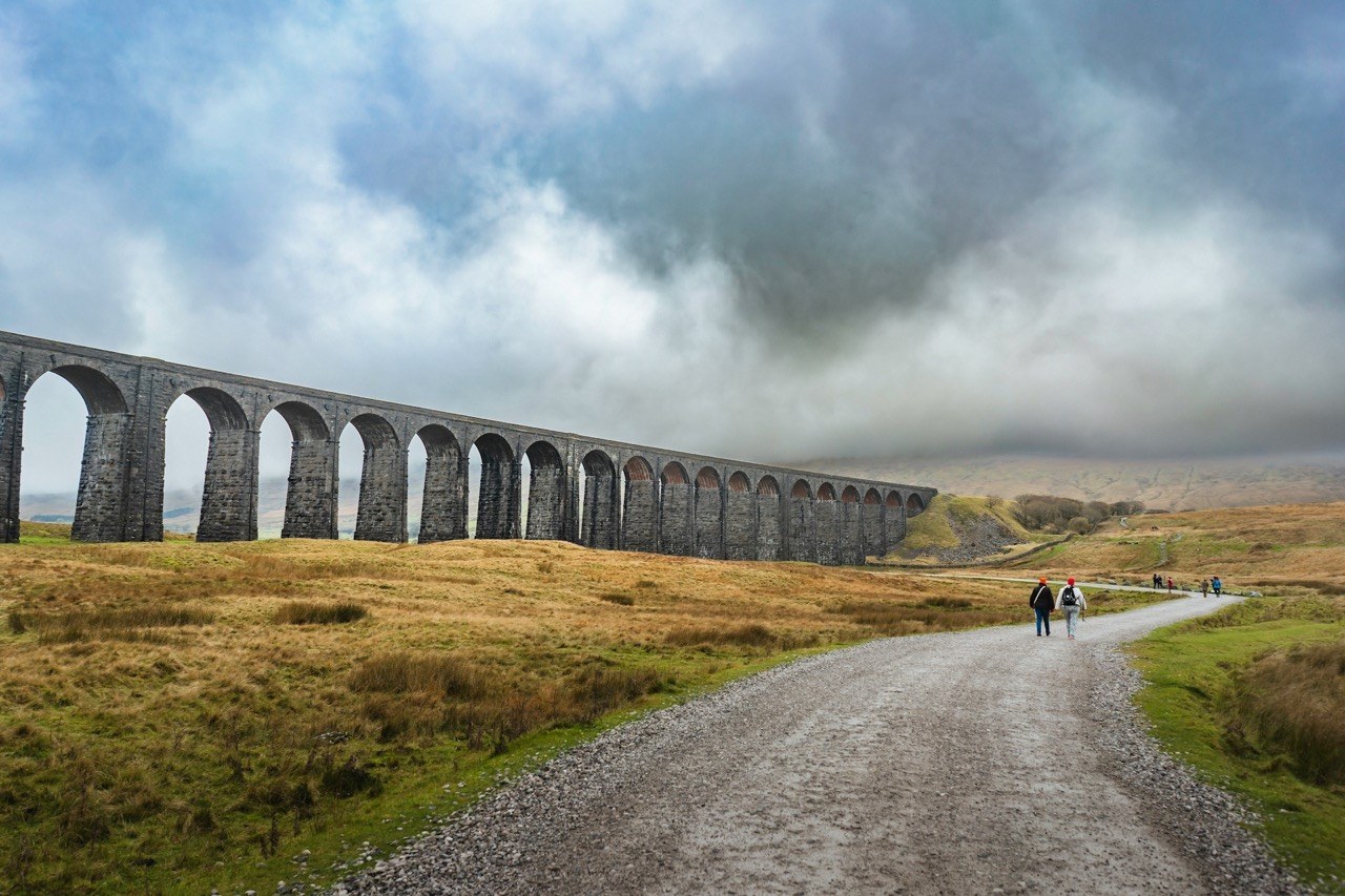 Hikers on the Yorkshire 3 Peaks route overlooking Ribblehead Viaduct